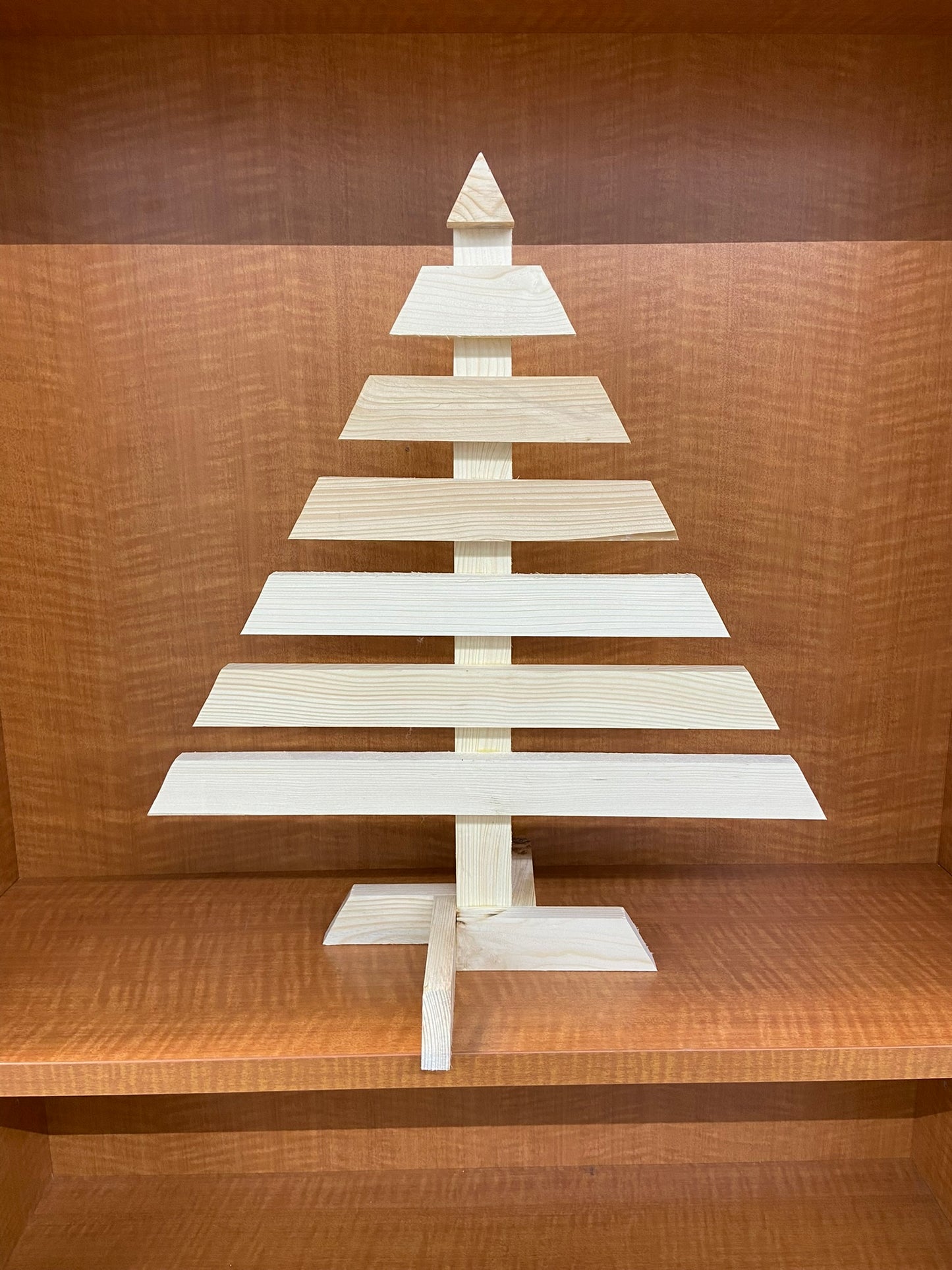 Wooden Christmas tree decoration on a wooden shelf