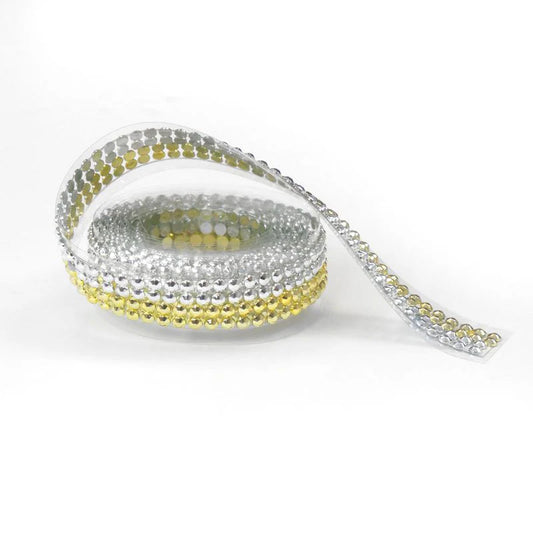 Roll of silver and gold beaded ribbon on a white background