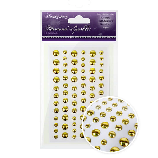 Packaging of gold stud embellishments with a close-up inset on a white background