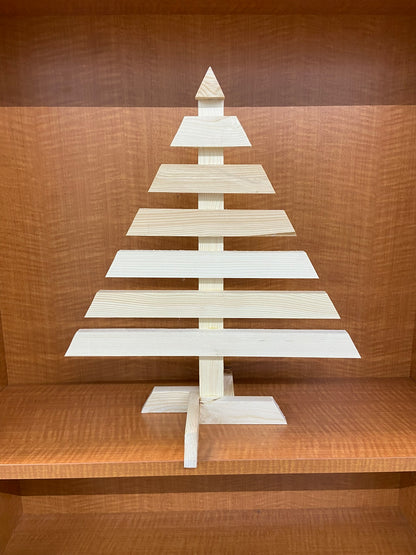 Wooden Christmas tree decoration on a wooden shelf