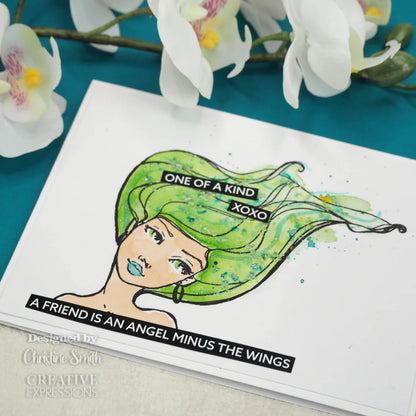 Card with green-haired character illustration and text on a teal background with flowers.