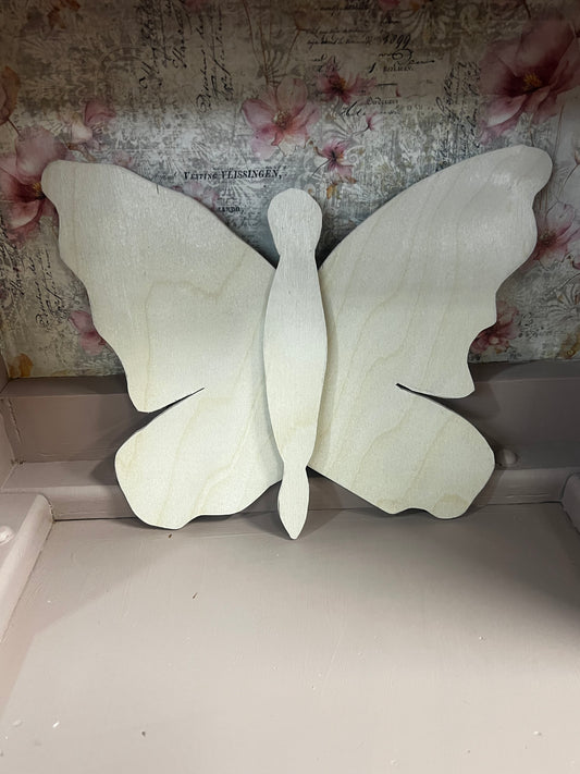 White butterfly wings on a textured surface with floral patterns
